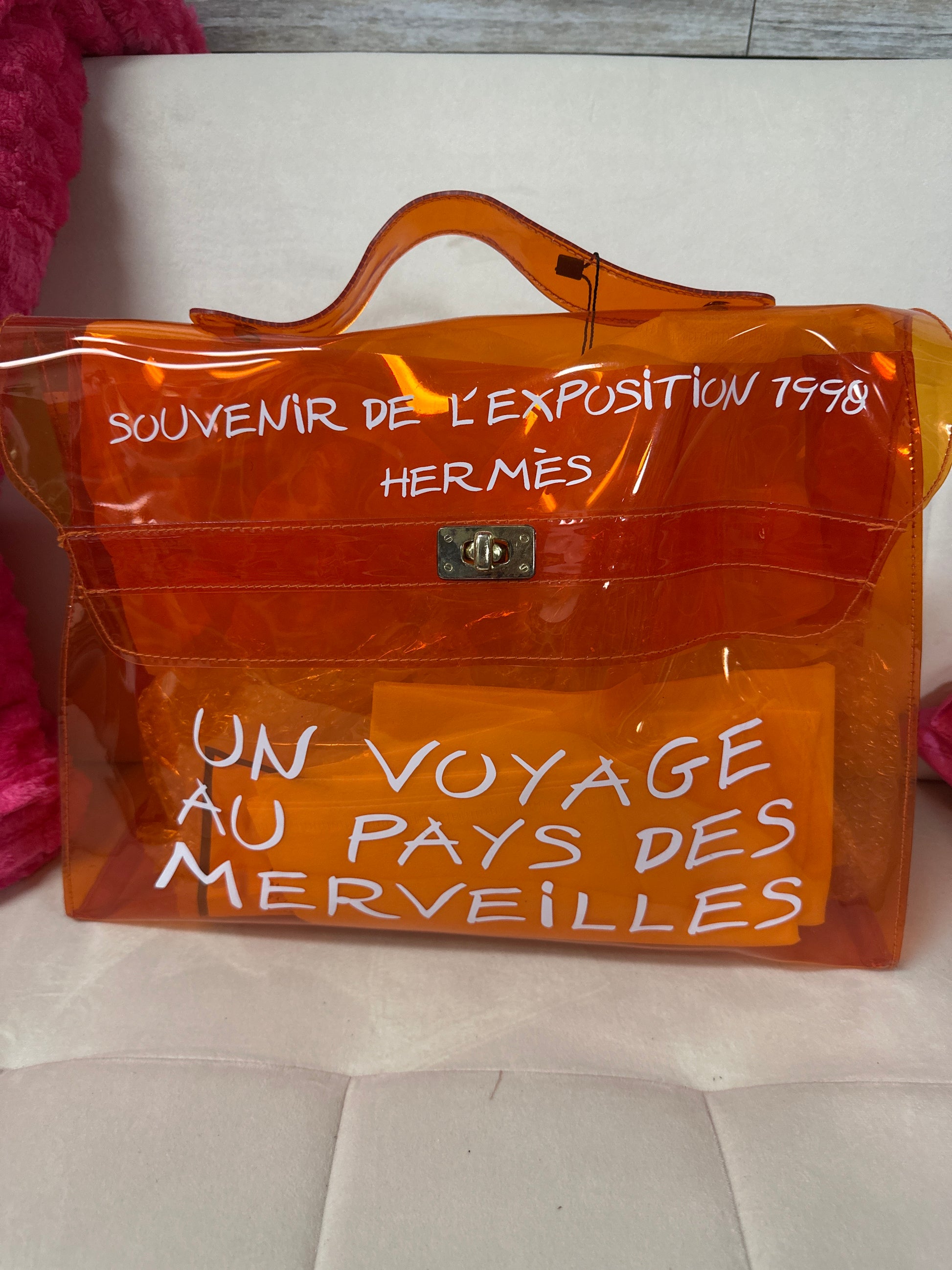 Orange Hermes bag with text on a white background